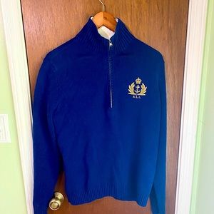 This is a lovely blue Ralph Lauren sweater with a gold Ralph Lauren emblem.